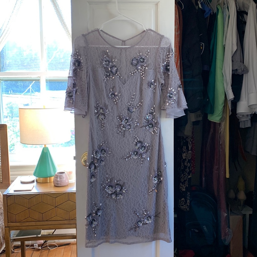 Soft lilac lace dress with intricate beading.